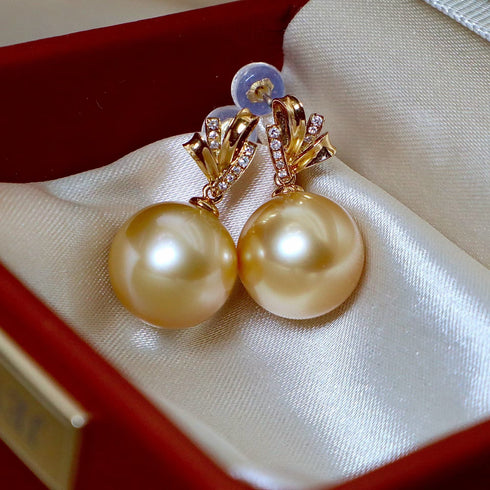 Earrings: pair of golden South Sea pearl drops with 18K gold, diamond-accented settings in a satin-lined box.