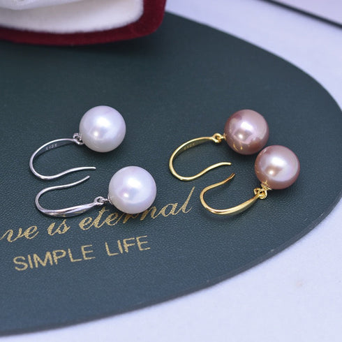 Earrings: 10–11mm freshwater pearl hoops, white pearls on silver hooks and pink pearls on gold hoops (2 pairs) by House Of Pearls.
