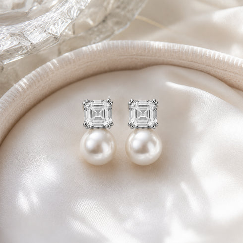 Earrings, pair of freshwater white pearl drops with square clear cube stud tops