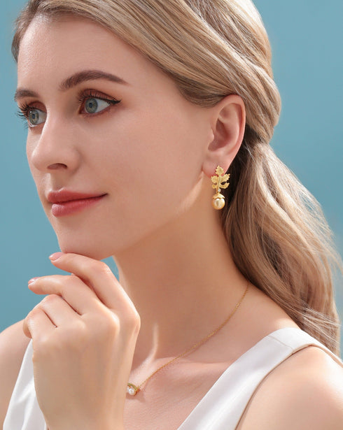 Earrings: 10–11mm Golden South Sea Baroque pearl with gold maple-leaf motif, House Of Pearls