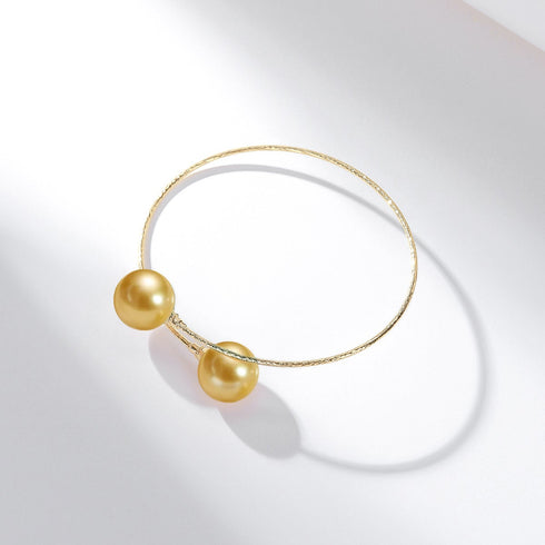 Bracelet with two 10-11mm Golden South Sea pearls on an 18k gold bangle by House of Pearls-TA