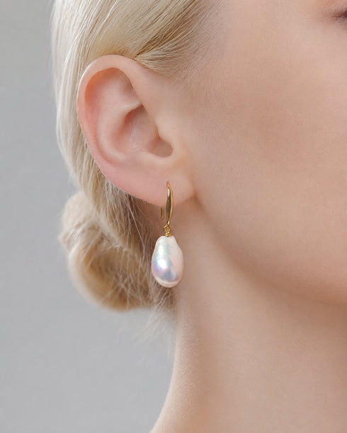 Earrings: gold hoop with 10–12mm teardrop baroque pearl pendant.