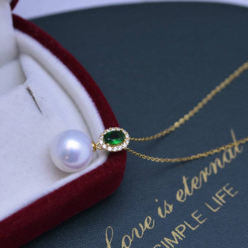 Necklace with 11-12mm freshwater pearl pendant and green gemstone on a gold chain