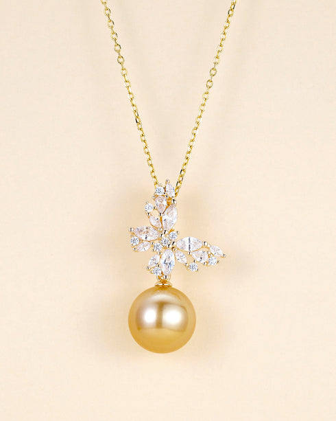 Butterfly pendant necklace with clear cubic zirconia and a golden South Sea pearl on a gold chain