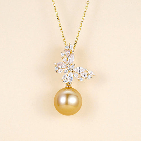 Butterfly pendant necklace with clear cubic zirconia and a golden South Sea pearl on a gold chain