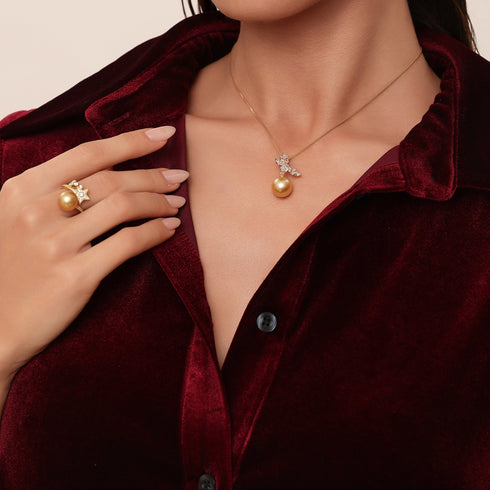 Butterfly pendant necklace with 11–12mm South Sea golden pearl and cubic zirconia accents; ring with pearl also shown.