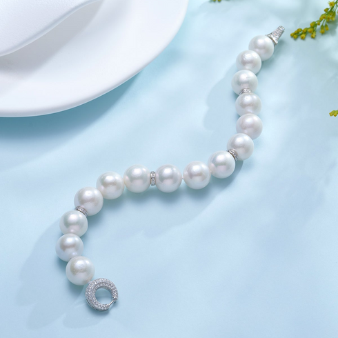 Bracelet: 11–13mm white Edison pearls by House of Pearls-JMY with diamond accents and a pavé clasp.
