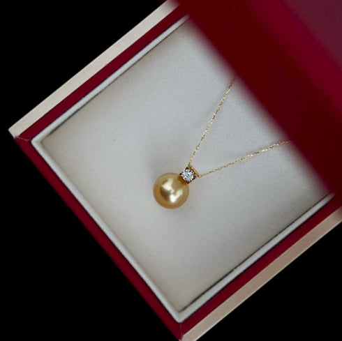 Necklace with 12-13mm Golden South Sea Pearl fairy drop pendant and diamond accent on a delicate gold chain.