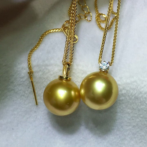 Pair of House Of Pearls Sasha pendant necklaces with 10–12mm golden South Sea pearls; one plain, one diamond-accent.