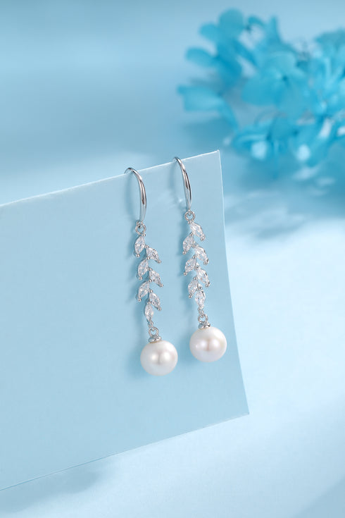 Earrings pair: 8-9mm freshwater pearl drops with long-leaf cubic zirconia leaf accents, silver-tone.