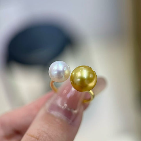 Ring featuring a golden South Sea pearl and a white Akoya pearl in an open, double-pearl design.