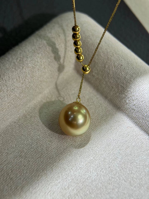 Y necklace with 10-11mm Golden South Sea pearl pendant and gold bead accents