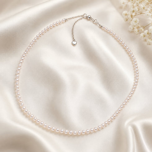 Pearl strand necklace with 4-5mm Aurora white freshwater pearls and a silver extender chain with heart charm.