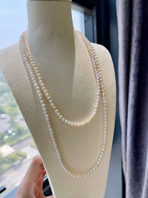 4–5mm Akoya seawater pearl opera-length necklace, double-strand white pearls on display bust