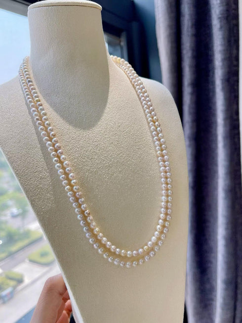 4-5mm Akoya Seawater Pearl Opera Necklace, double-strand ivory pearls on a beige display bust