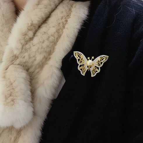 Brooch Golden South Sea Pearl Butterfly with pearl center, gold-toned filigree wings.
