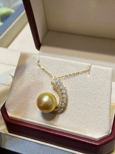 Necklace with 12–13mm Golden South Sea pearl and diamond-accented feather pendant on a 14K gold chain