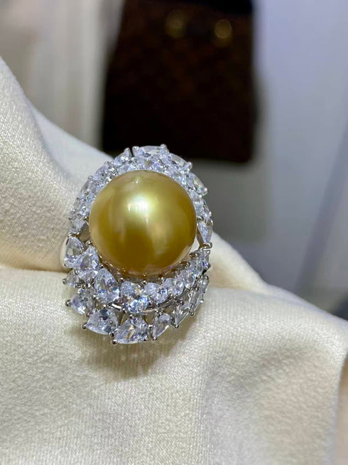 Ring featuring a 12–13mm golden South Sea pearl surrounded by a crystal halo
