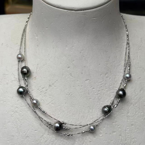 Triple-layer Tahitian Baroque Pearl necklace, 6–10mm, on silver chains.