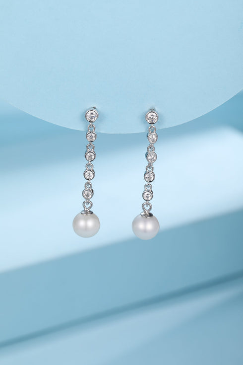 Pair of silver-tone freshwater pearl long-drop earrings with cubic zirconia stones along the chain