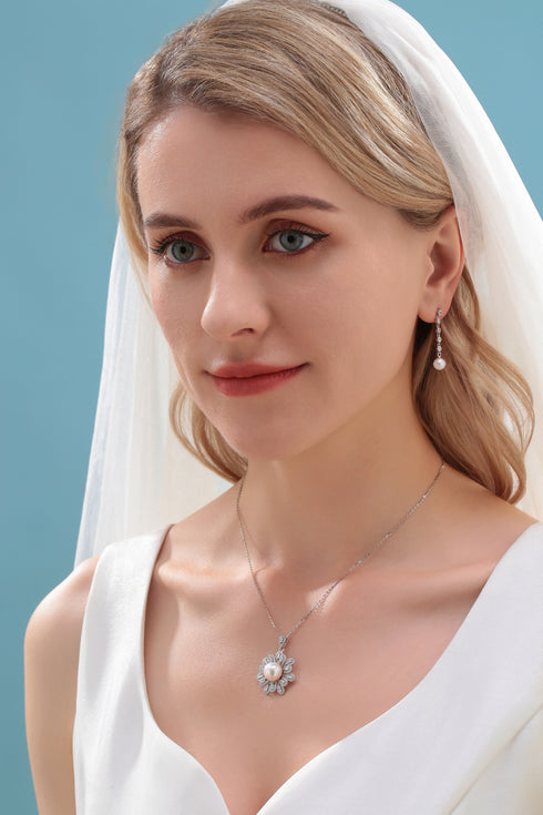Earrings: 6-7mm freshwater pearl with long-drop cubic zirconia on a silver-tone chain.