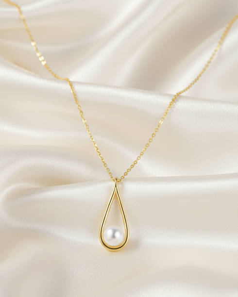 Pearl teardrop pendant necklace with a white freshwater pearl on a delicate gold chain