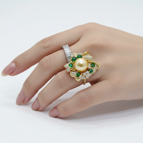 12mm Golden South Sea Pearl Flower Ring with gold-tone petals, green stones, and pavé diamonds.