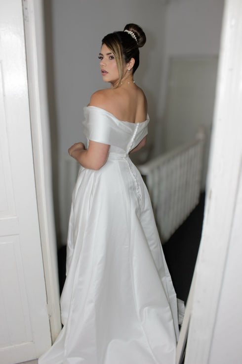Jessica Pearl Set: white pearl jewelry on a model wearing an off-shoulder white gown