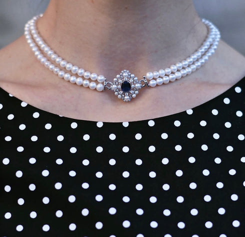 White freshwater pearl double-strand choker necklace with ornate crystal-studded clasp.