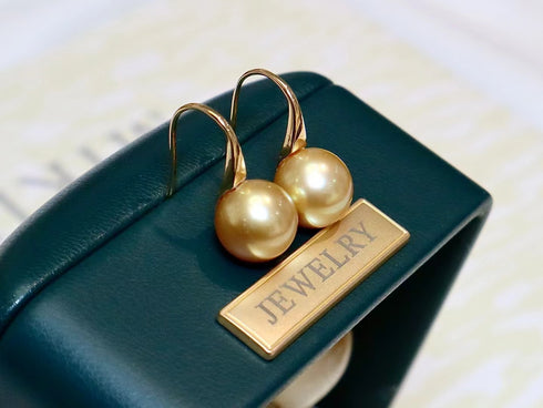 Pair of earrings featuring 9-10mm golden South Sea pearl drops on 18K gold hooks