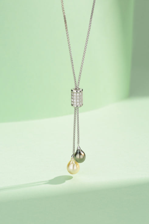 9-11mm Double Pearl Pendant Necklace with a diamond-studded silver cylinder and two hanging yellow and olive-green pearls