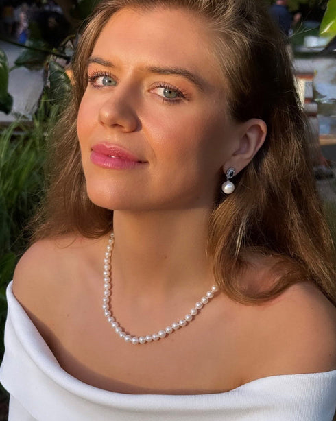 Earrings, blue gemstone tops with 11–12mm freshwater pearl drops.