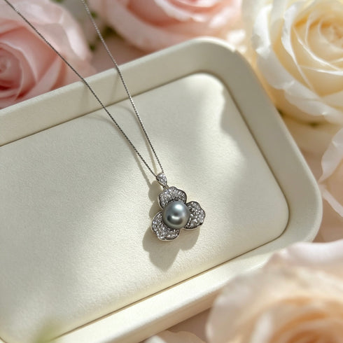Necklace: Flora pendant with 10–11mm Tahitian South Sea pearl surrounded by diamond-studded flower on a silver chain