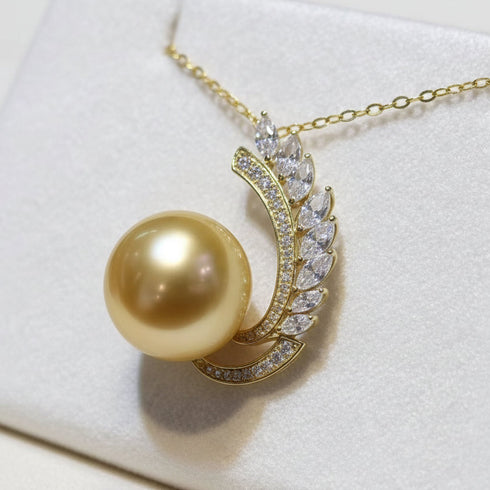 Necklace featuring a 12–13mm golden South Sea pearl with a diamond-encrusted feather pendant in 14K gold.