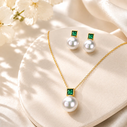Necklace and earrings set by House Of Pearls TA with white freshwater pearls and green gemstones on gold-tone metal