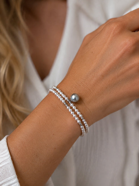 Double-Strand Akoya Silver-Blue Pearl Wrap Bracelet on the wrist; three white pearl strands with a silver-blue accent pearl.