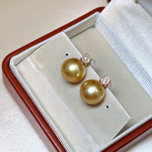 Earrings pair by House Of Pearls FT: golden South Sea pearl drops with diamond halo in 18K gold