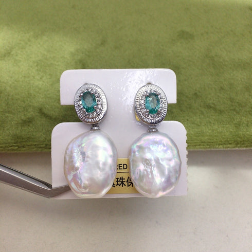 Coin Baroque Freshwater Pearl Drop Emerald Accent Earrings, pair with emerald-accented coin tops and large iridescent pearl drops.