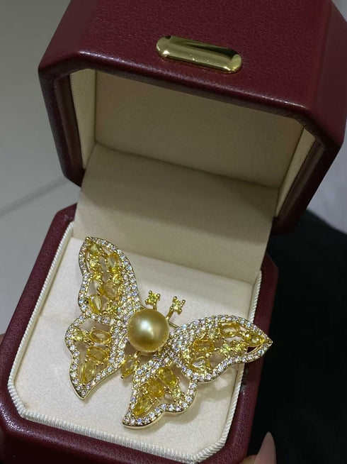 Golden South Sea Pearl Butterfly Brooch with pave crystals on gold-tone wings, in a burgundy jewelry box