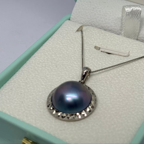 Blue Mabe Pearl pendant necklace with silver-tone setting on a delicate chain.