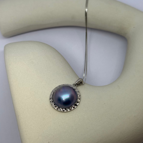 Blue Mabe Pearl Pendant Necklace by House of Pearls, featuring a large blue pearl set in a silver studded bezel