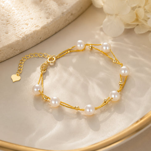 Layered White Freshwater Pearl Bracelet with gold-tone chain and heart charm