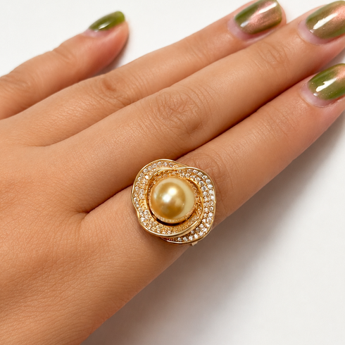 Ring: 10–11mm Golden South Sea pearl rose halo ring in gold with pavé diamond halo.