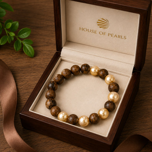 Bracelet: Agarwood & Golden South Sea Pearl stretch bracelet in a wood jewelry box by House Of Pearls