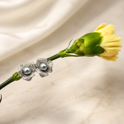 Earrings: pair of 7–8mm Japanese Silver Blue Akoya Floral Studs with textured silver petals and blue-grey pearls.