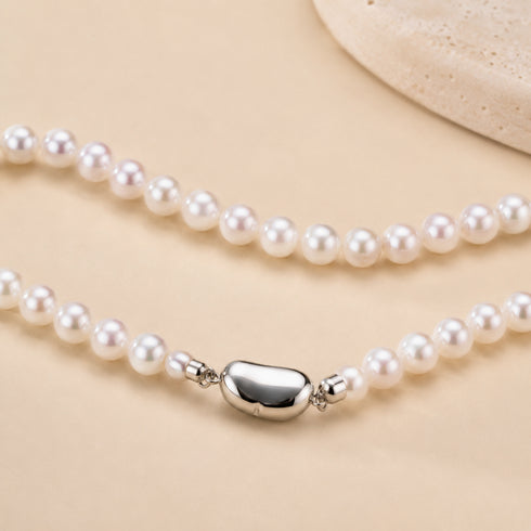 Pair of pearl strand necklaces with AAA 5-6mm Aurora pearls; white round pearls, silver barrel clasps
