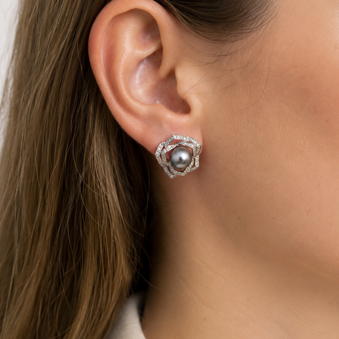 Stud earrings featuring a 10–11mm Tahitian pearl with a rose floral CZ halo in sterling silver.