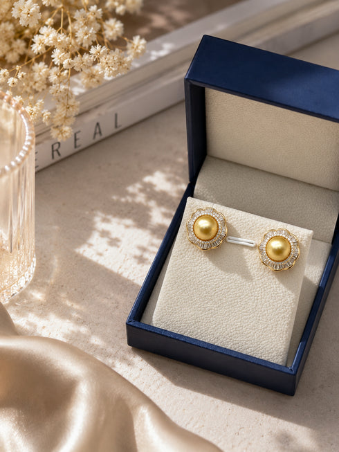 Earrings: 9-10mm Golden South Sea Pearl Floral Halo by House Of Pearls, gold with diamond halo, in navy box.