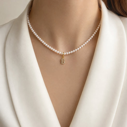 Dainty initial B pavé CZ charm pendant on a gold-tone pearl necklace by House Of Pearls