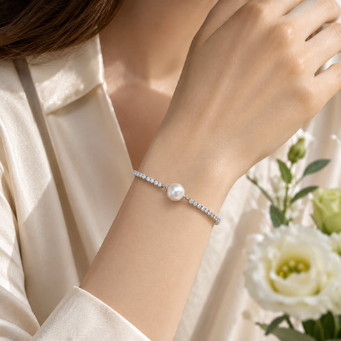 Aurora White Freshwater Pearl Tennis Bracelet with a pearl centerpiece and crystal-studded band